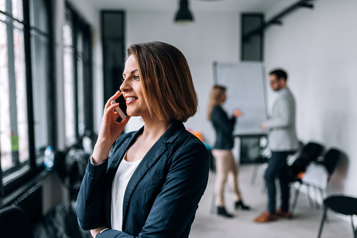 Business woman on the phone in an office.